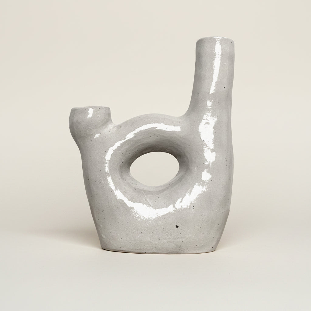 Ceramic wall hook with a textured surface on a plain background