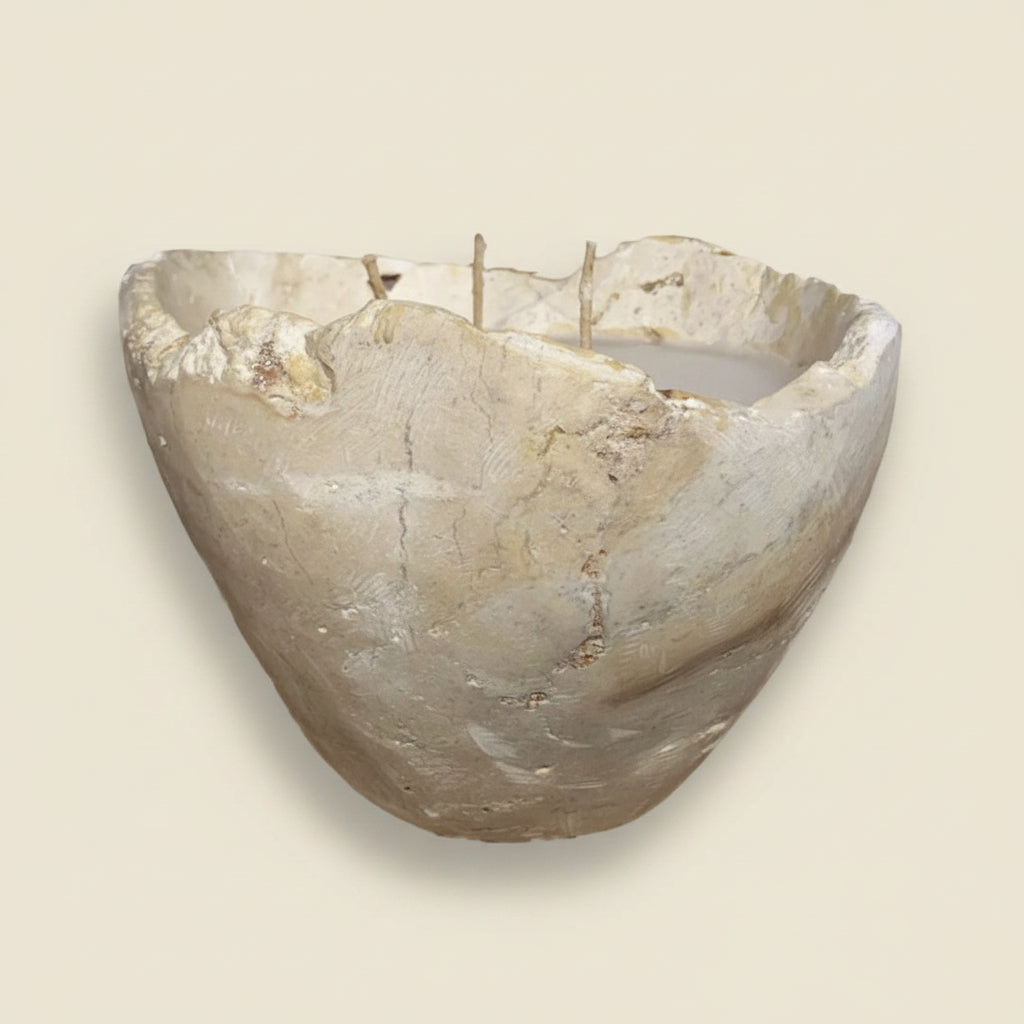 Decorative stone wall bowl on a textured white wall