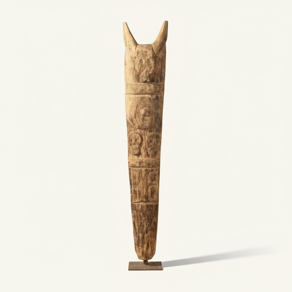 A tall, hand-carved wooden totem pole sculpture with animal and human figure carvings, displayed on a small wooden base against a clean off-white background.