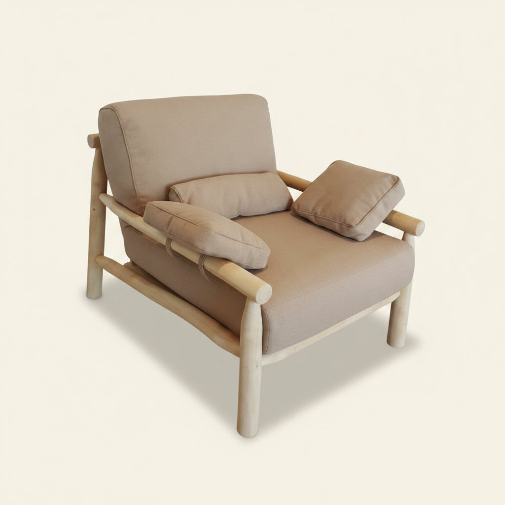 A light beige upholstered adjani outdoor chair with a natural wood frame, shown with two matching throw pillows .