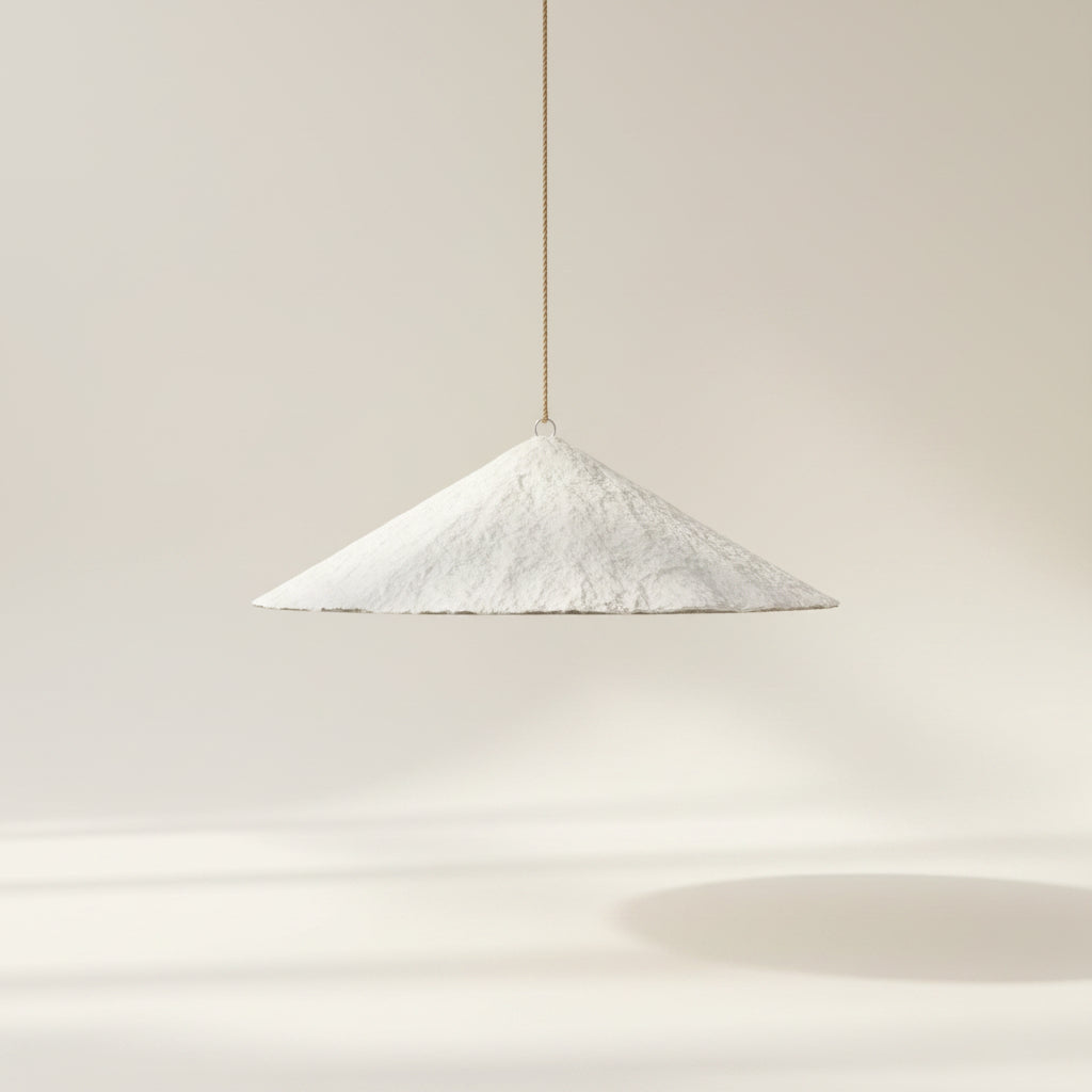 A white paper cone shaped pendant light, 80cm in diameter. The Alaya by Bisque Traders.