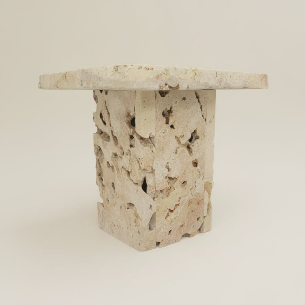 Decorative stone side table with natural texture on against a neutral wall