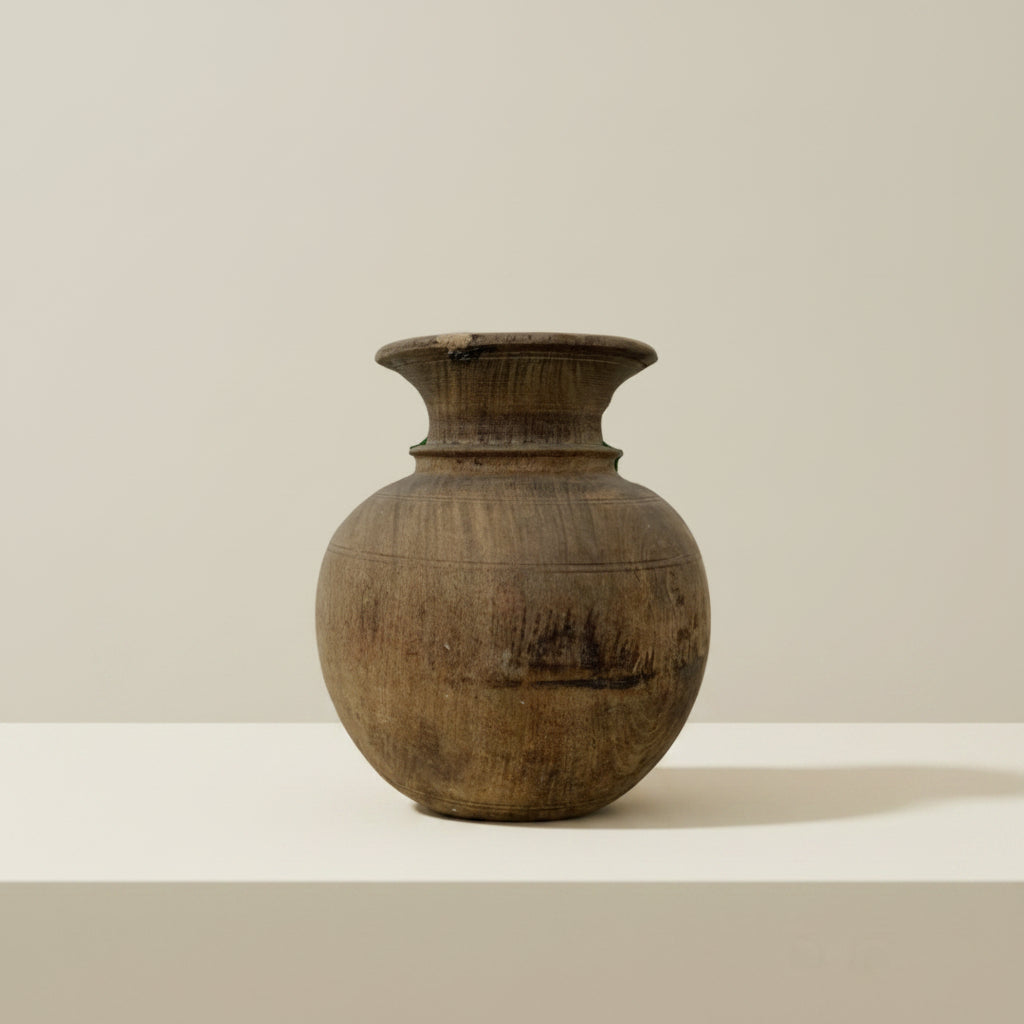 Wooden vase on a textured beige wall