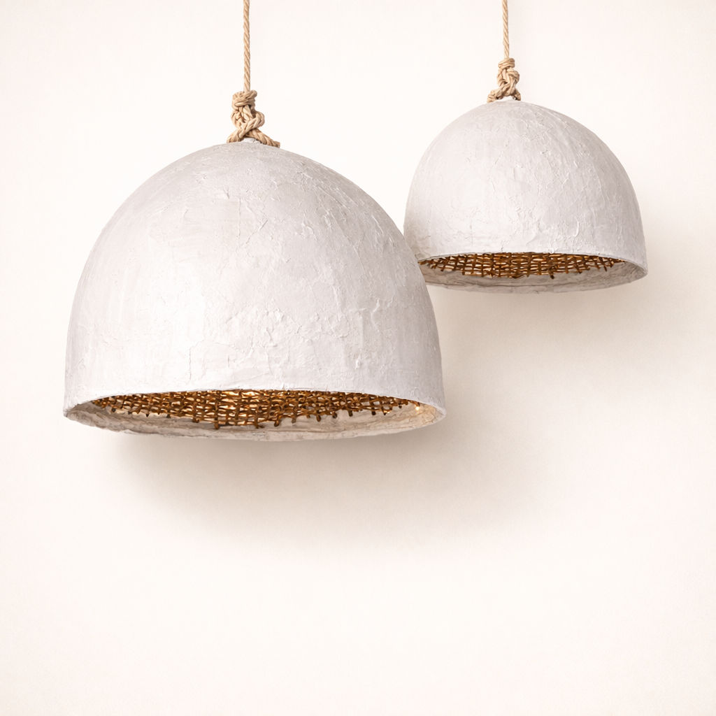 Two white Chinara Clay pendant lights with rattan interior and white clay coating on a neutral background