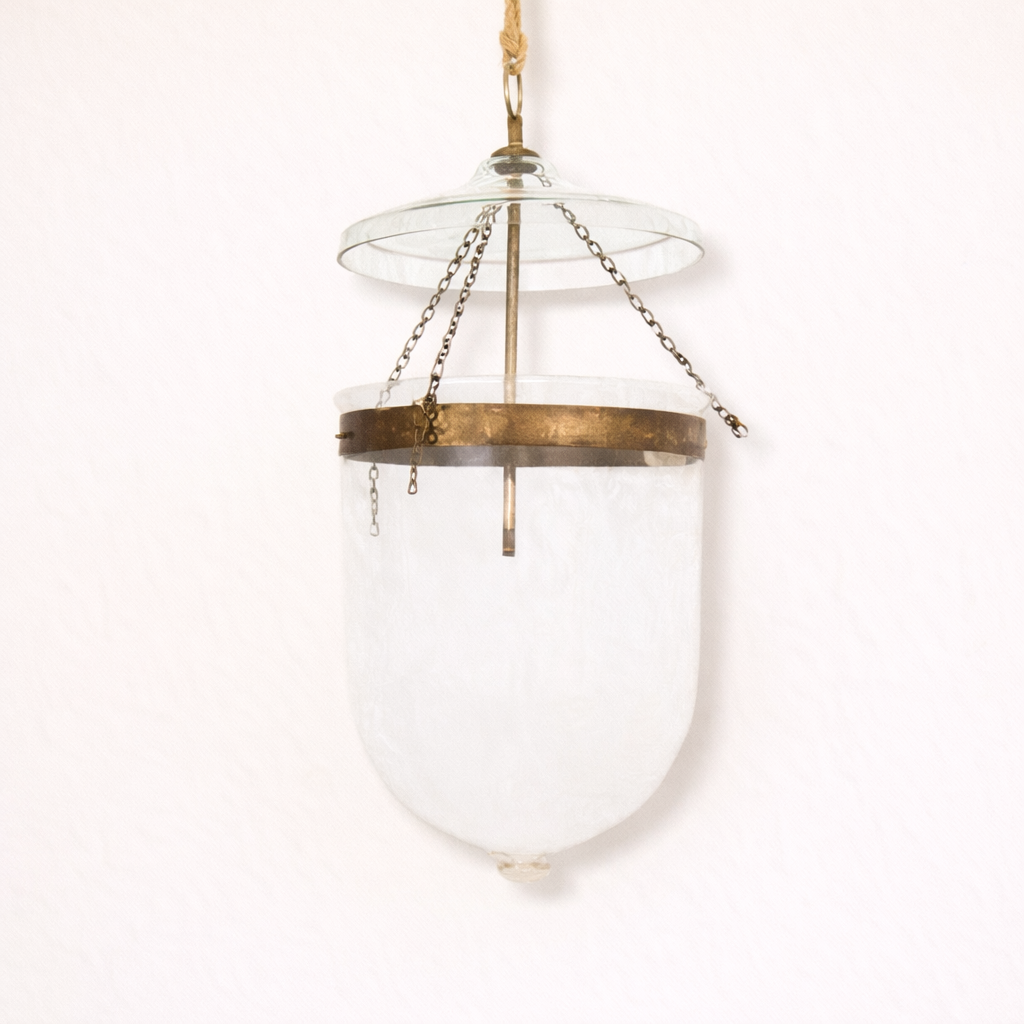 Decorative glass bowl Chloe pendant light with glass shade and brass fixture on a white background