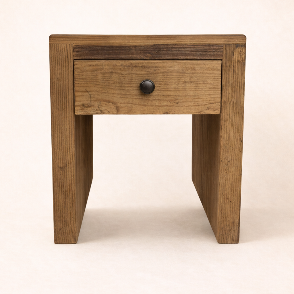 Wooden side table with a drawer on a beige background