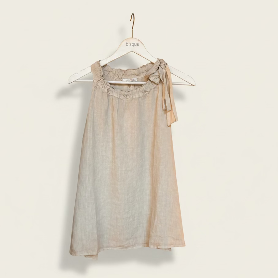 Beige sleeveless Italian linen top with bow detail on a hanger against a white background