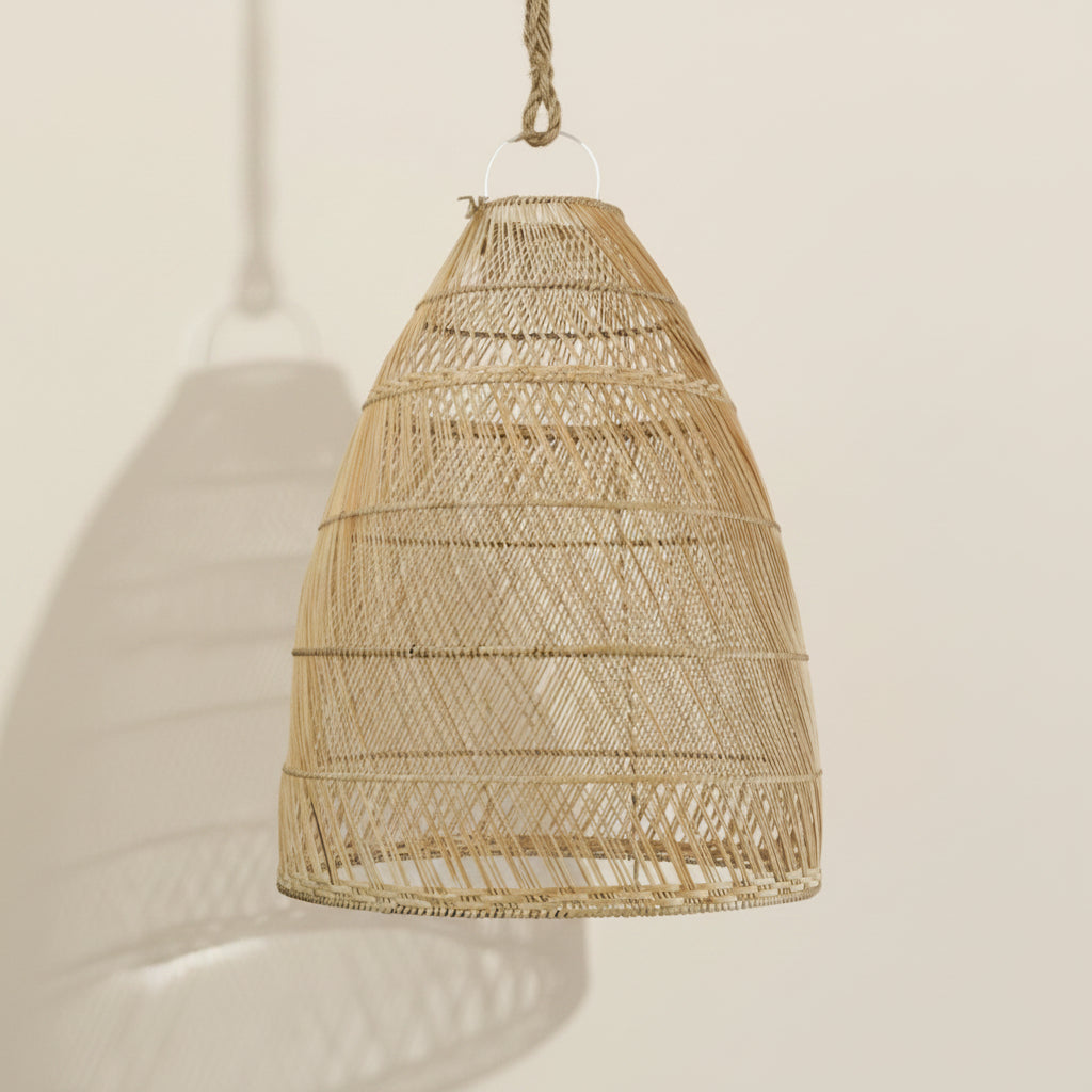 Woven Inuir dome pendant light hanging against a plain wall