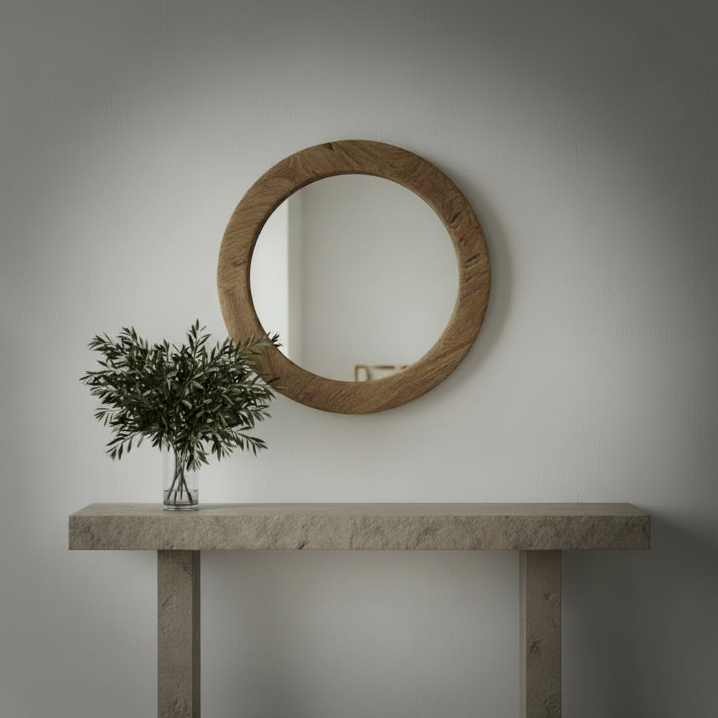 Round wooden teak mirror with a rustic finish on a wooden floor.