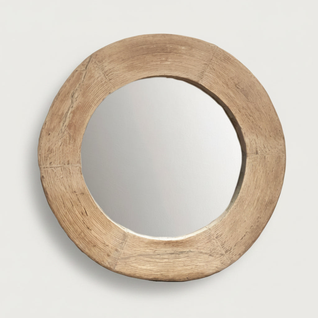 Round wooden mirror on a light gray background