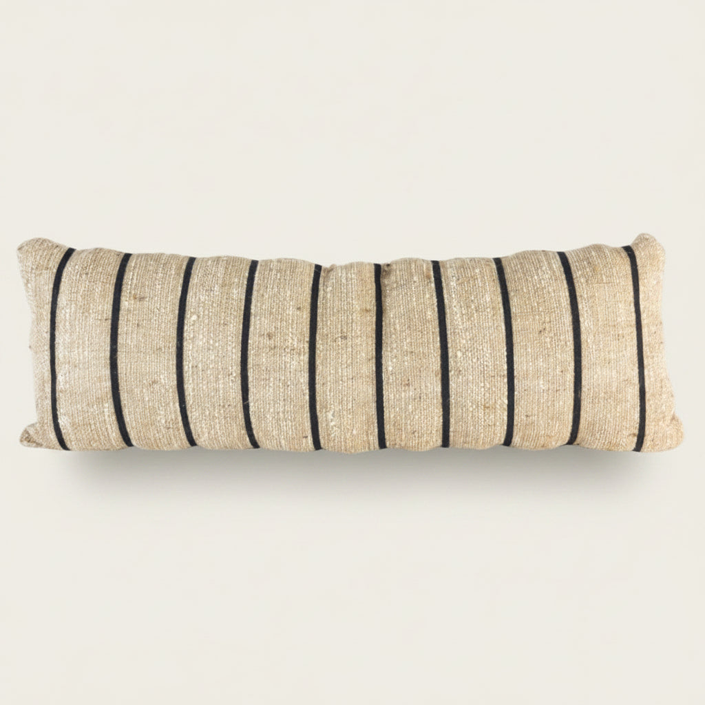 Long rectangular pillow with beige and black stripes on a white background