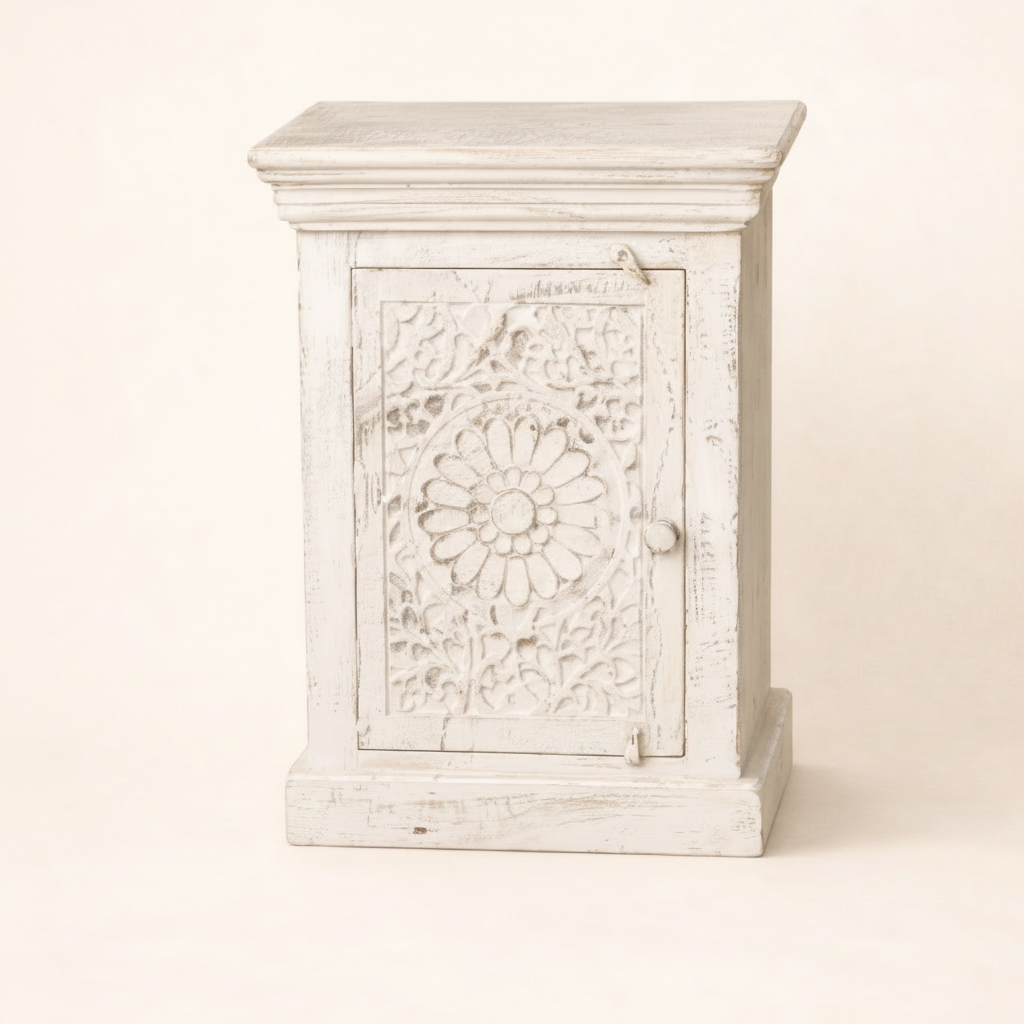 White wooden jewelry box with floral carvings on a beige background