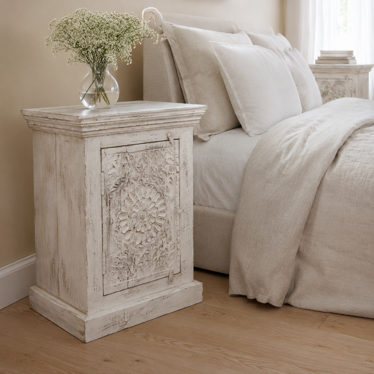 A distressed white carved wooden nightstand, indian antique with cornice and kickboard detailing. available in left and right side, with beautiful flower botanical relief.