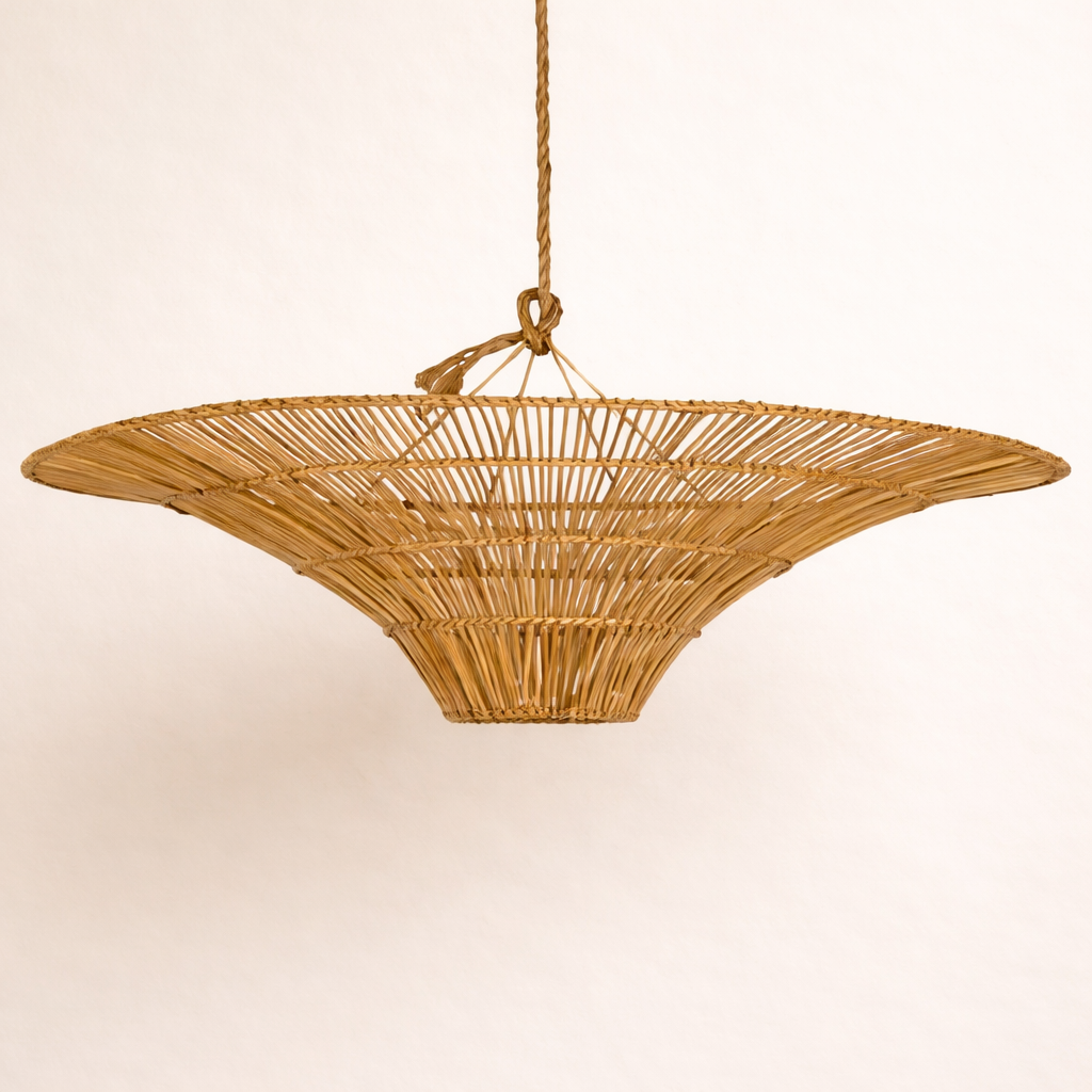 Woven rattan Tano pendant light on a plain background