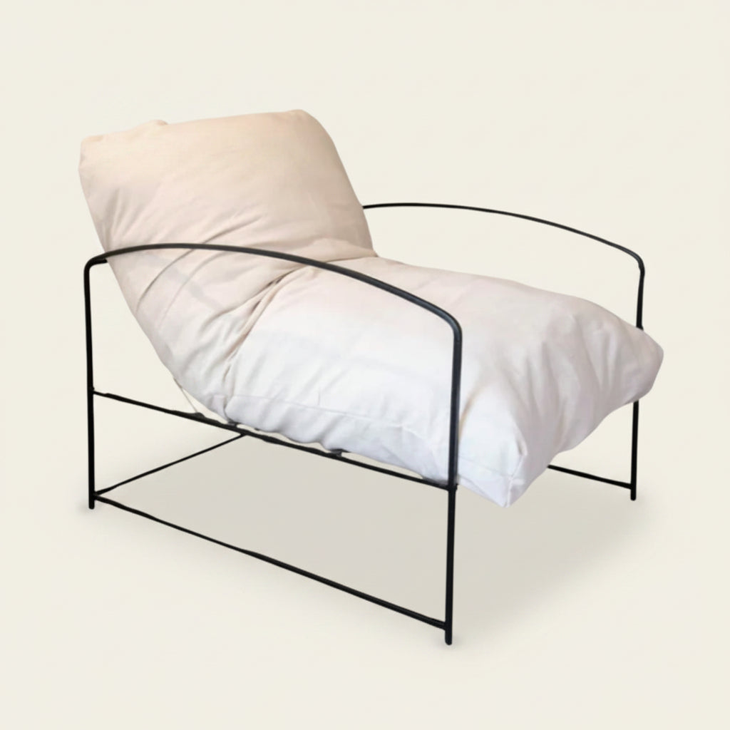 Taye soft cream cushion on a black metal framed occasional chair, Bisque Traders
