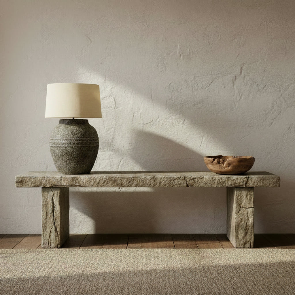 A washed grey finish terracotta table lamp base with a beige lampshade on top.