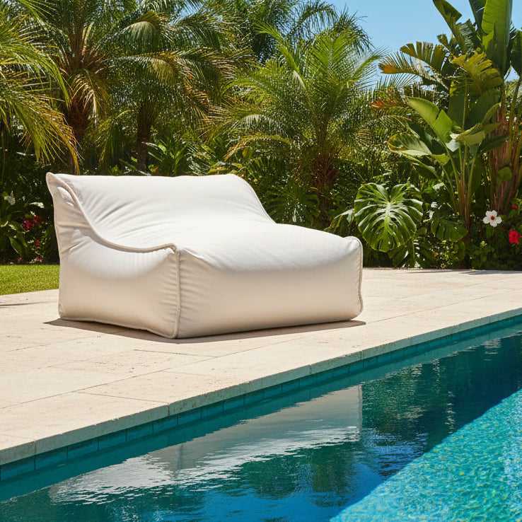 A white outdoor fabric single sun lounge with a cushioned design.