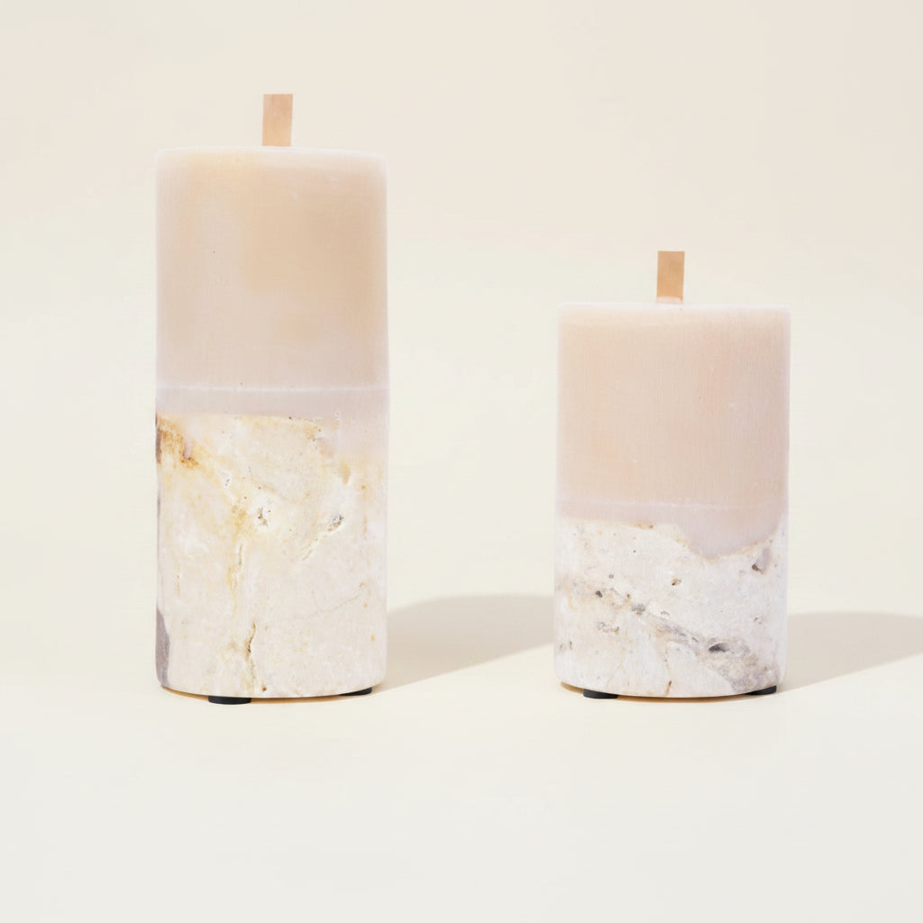 Two fossilised coral candle holders with cream.
