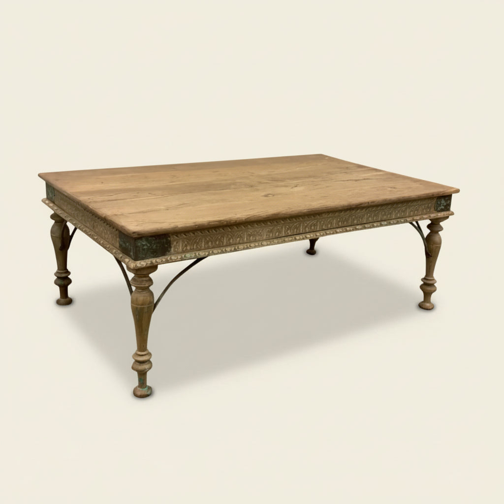 


Wooden carved Indian table with decorative legs against a textured white wall