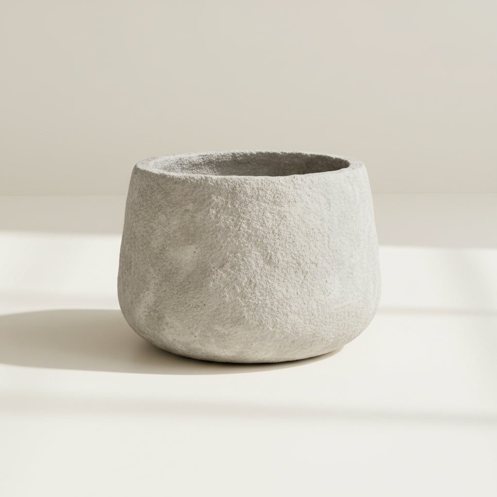 Concrete pot with a textured surface on a white background