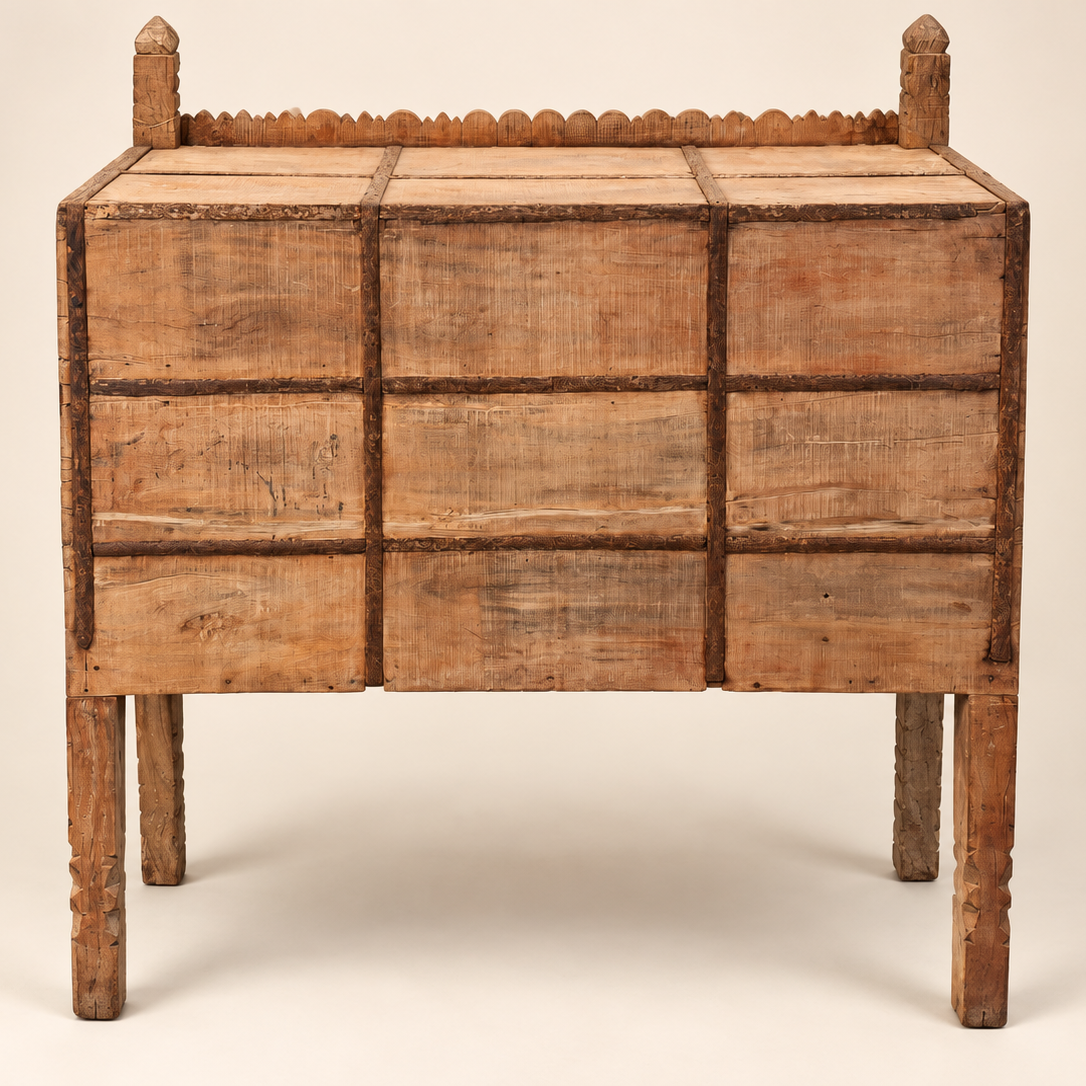 An antique wooden chest or cabinet with a grid pattern of drawers, featuring turned legs and a decorative beaded top rail, shown against a plain light beige background.