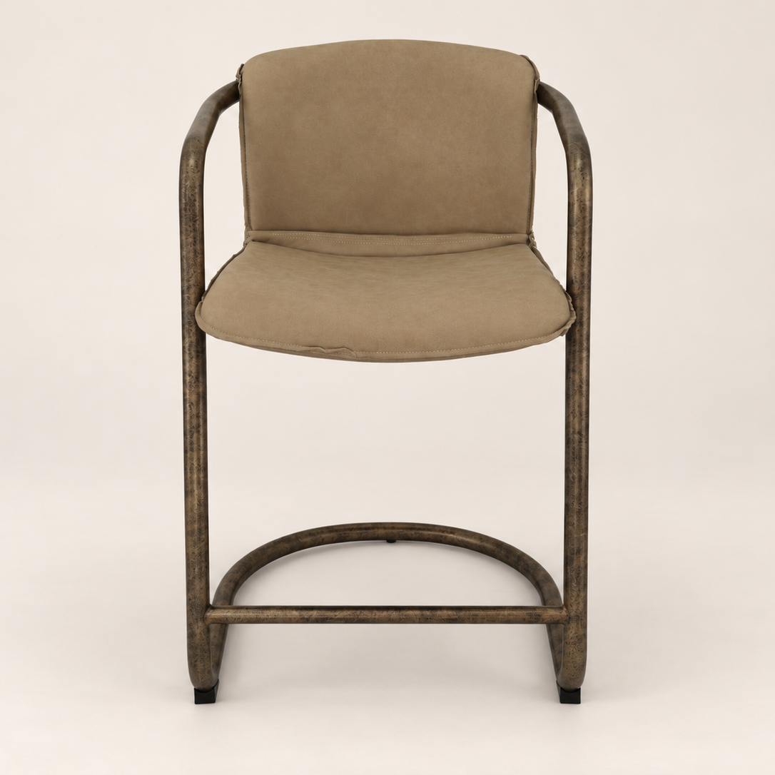 A modern bar stool with a distressed dark brown metal frame and taupe-beige upholstered seat and backrest, shown against a neutral light beige background.