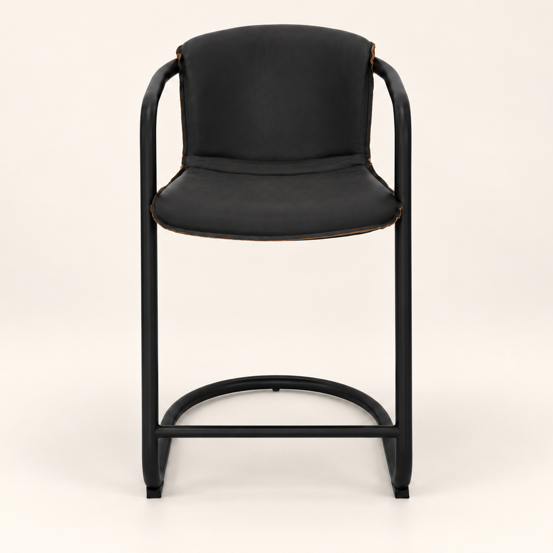 A modern black bar stool with a curved tubular metal frame, black upholstered seat and backrest, and small brown leather accents at the arm attachments, shown against a plain off-white background.