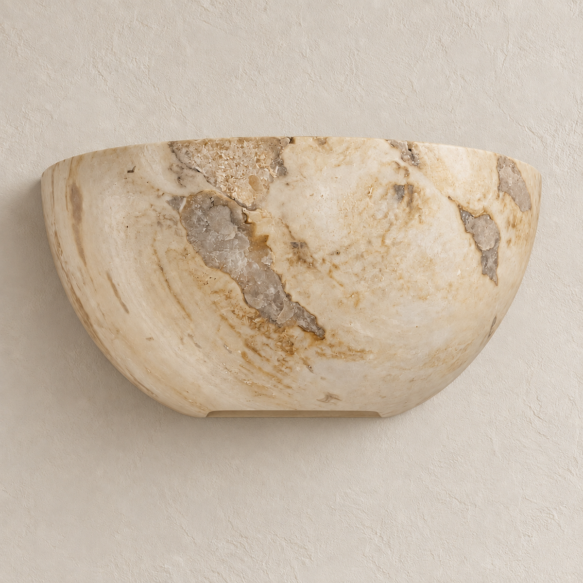 A semi-circular stone wall sconce made of beige and cream marble with natural brown and gray veining, mounted on a textured beige plaster wall.