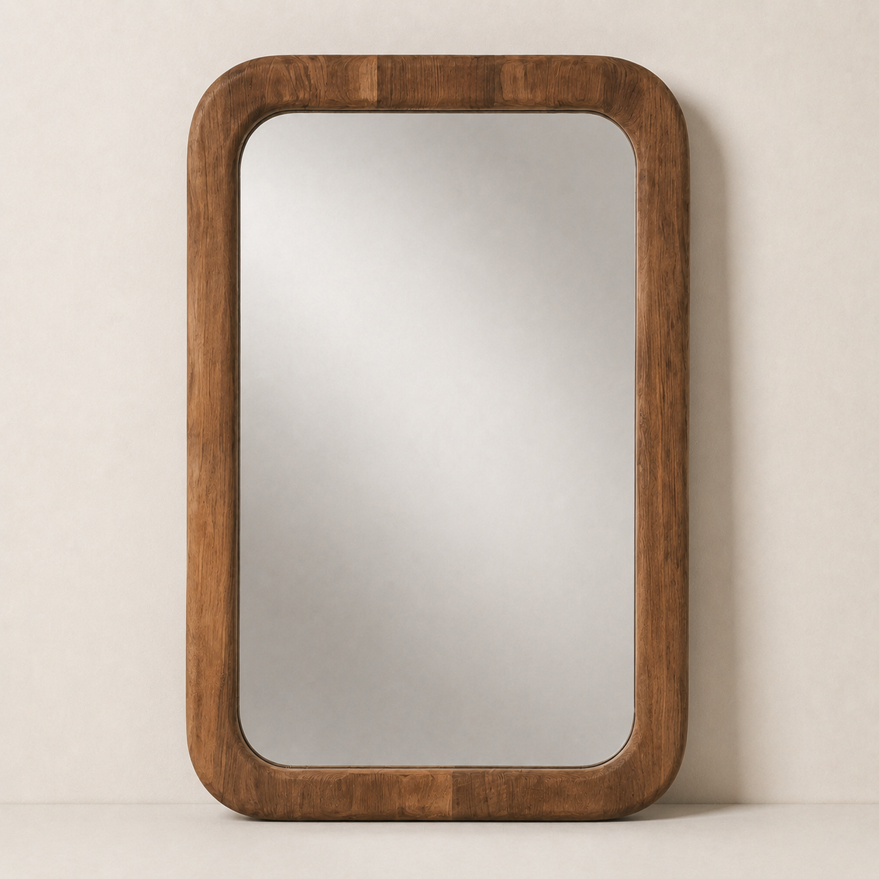 A rectangular wall mirror with a thick, rounded wooden frame in a warm medium brown finish, set against a neutral beige background.