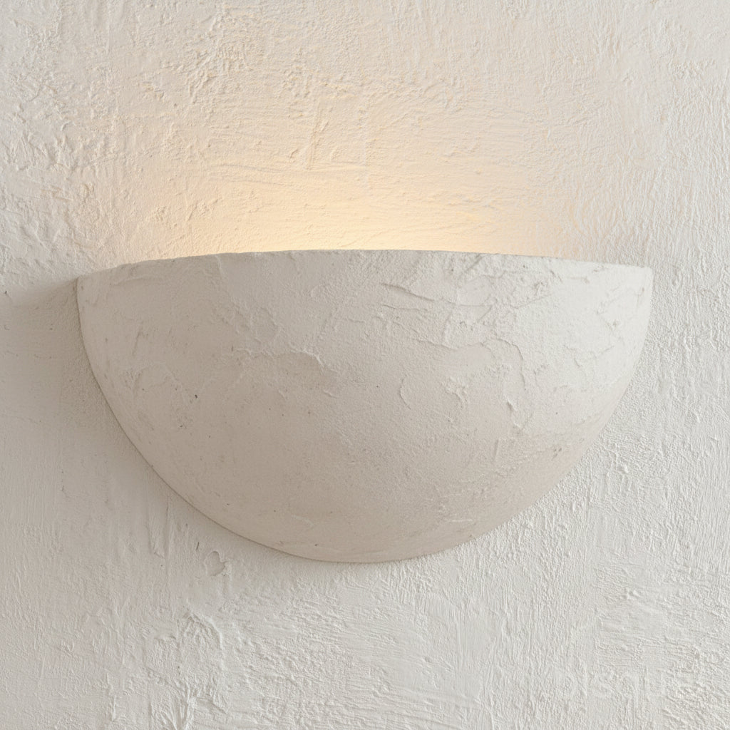 White textured wall sconce on a white textured wall