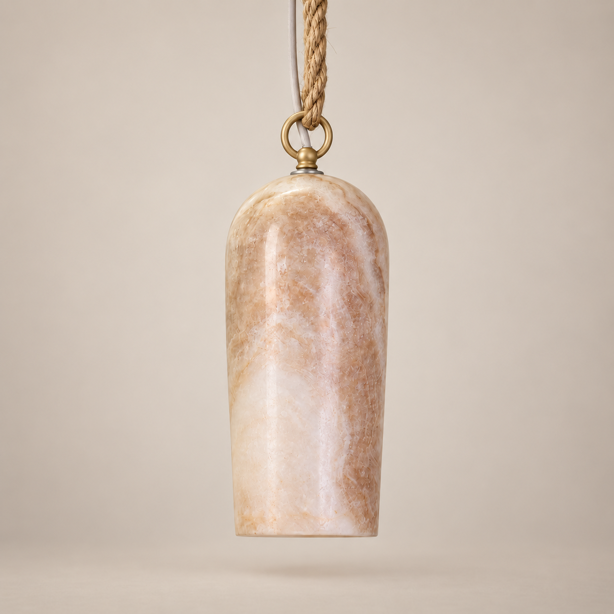 A hanging pendant light with a polished beige and white marbled stone shade, suspended by a gold-toned ring from a braided rope cord, set against a solid warm beige background.