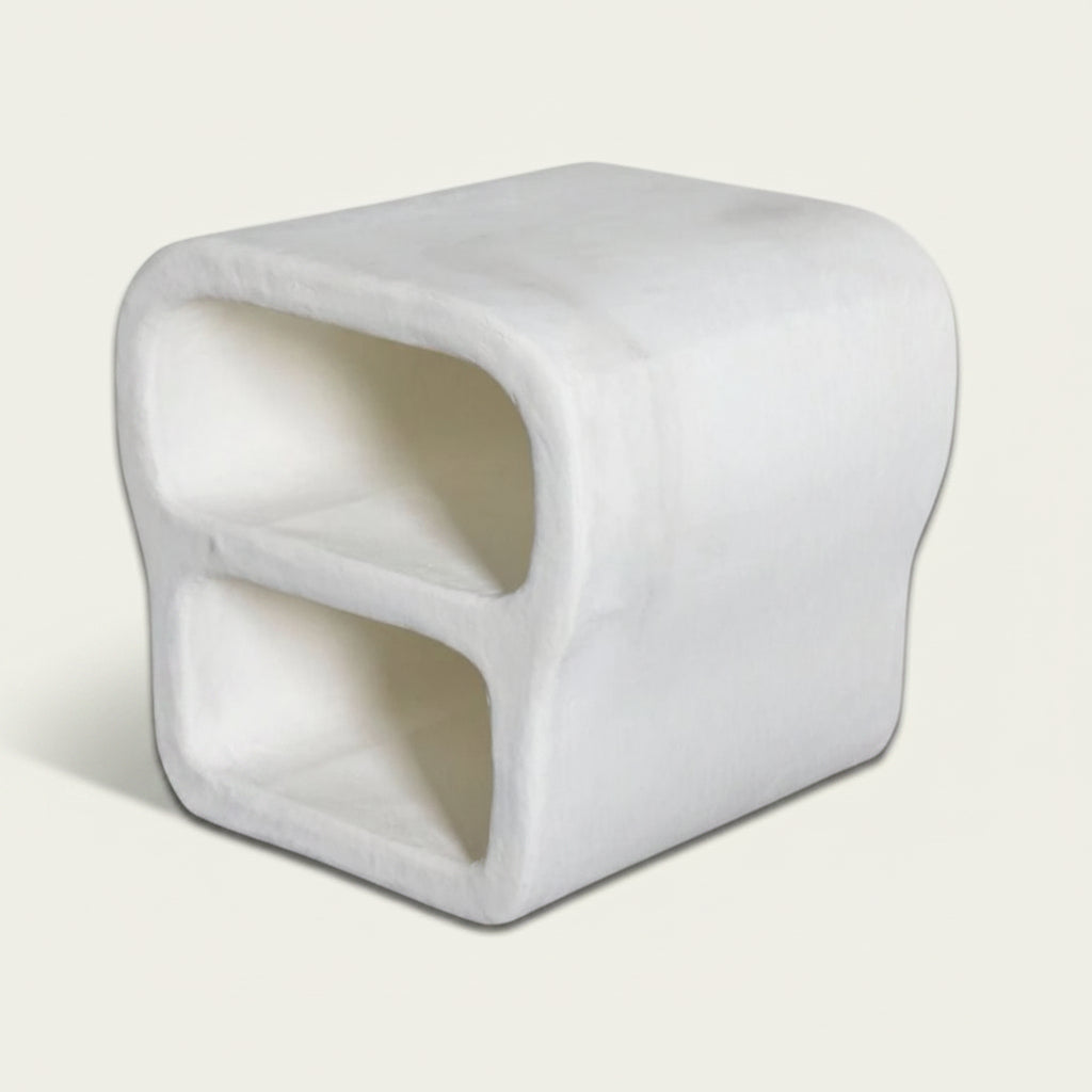 White cube-shaped object on a textured white background