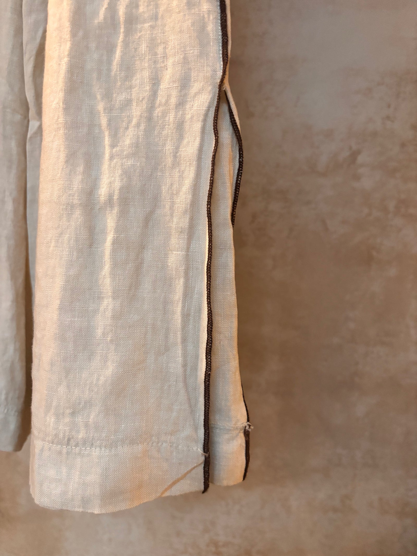 Close-up of beige fabric of ariosa linen pant leg detail