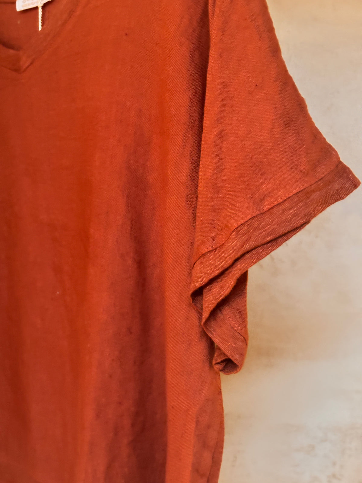 Coco 100% cotton Armonia t-shirt on a hanger against a neutral background