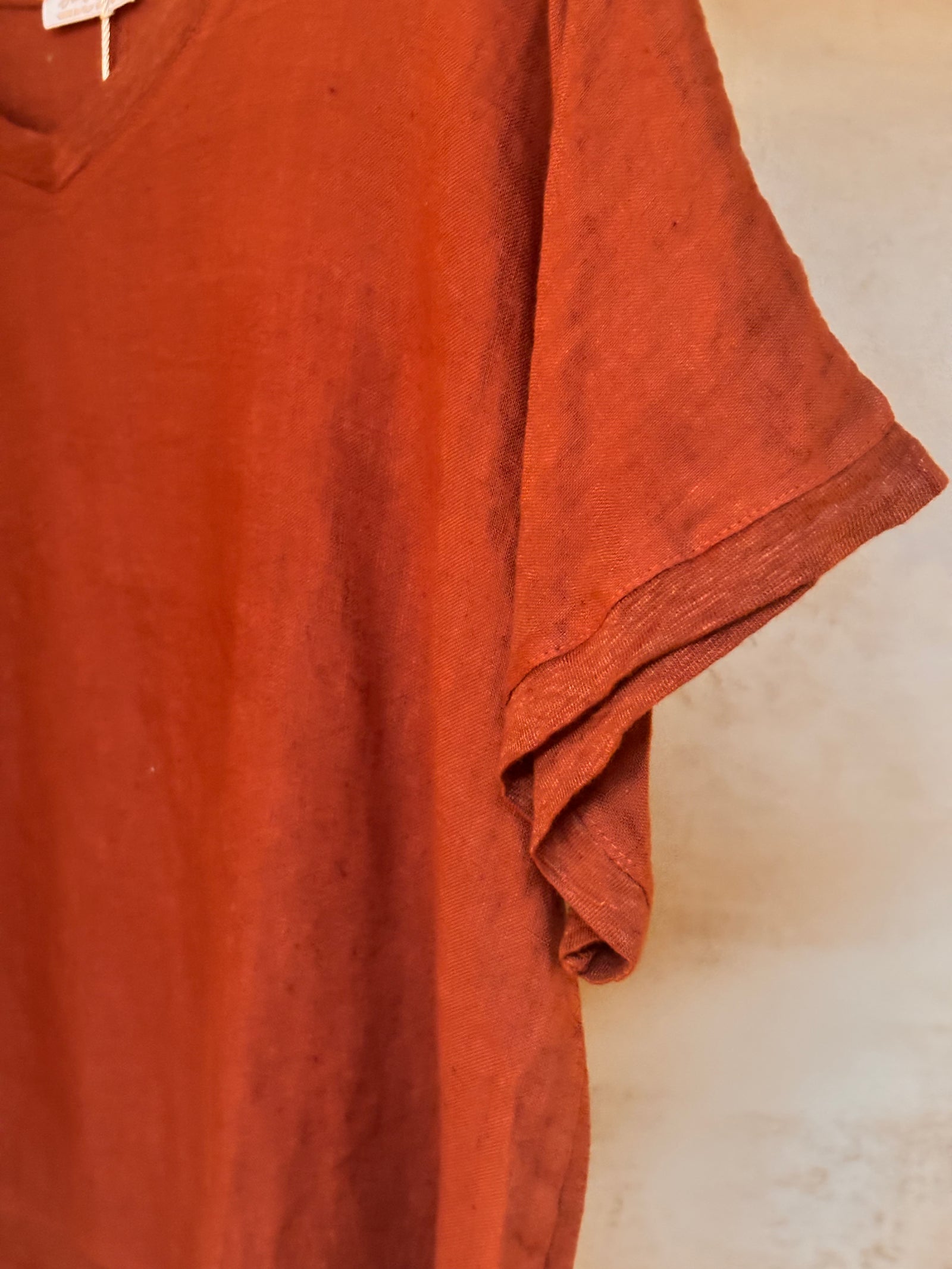 Coco 100% cotton Armonia t-shirt on a hanger against a neutral background