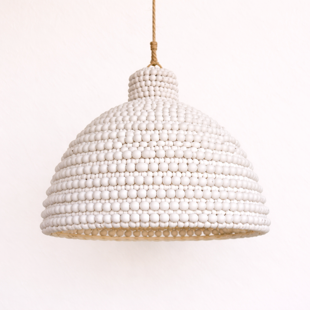 White wood beaded Cahya pendant light on a white background