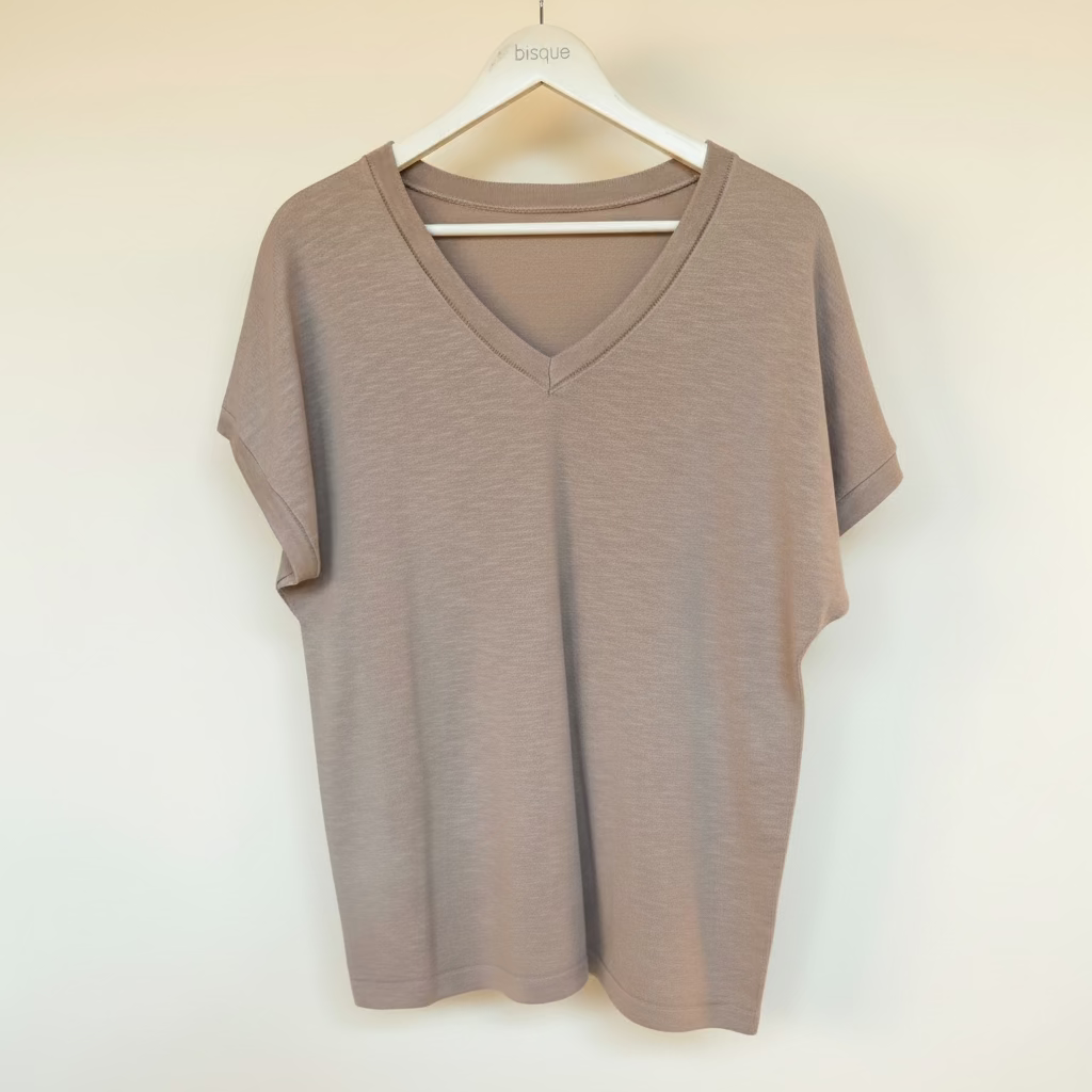 Brown pure cotton knit v-neck -t-shirt on a hanger against a white background