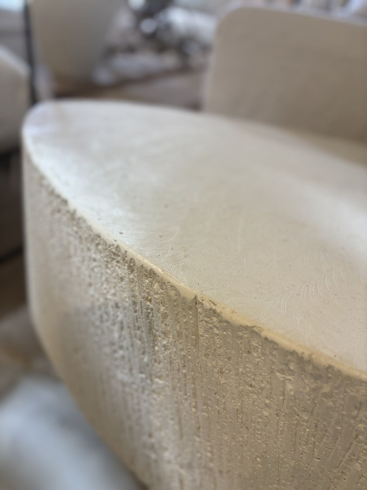 'Elena' GRC oval coffee table with rough stone appearance on the sides.