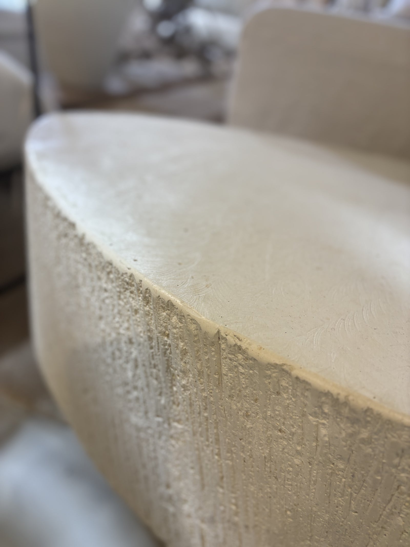 'Elena' GRC oval coffee table with rough stone appearance on the sides.