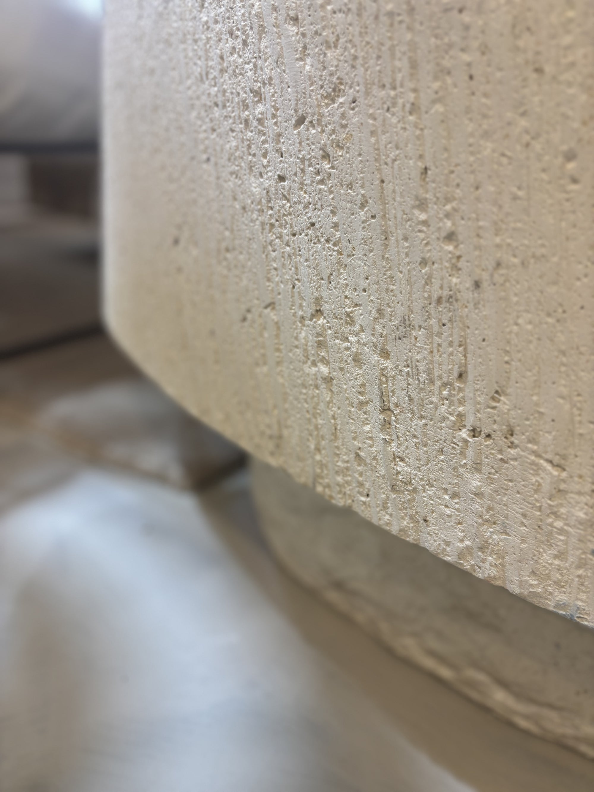 'Elena' GRC oval coffee table with rough stone appearance on the sides.