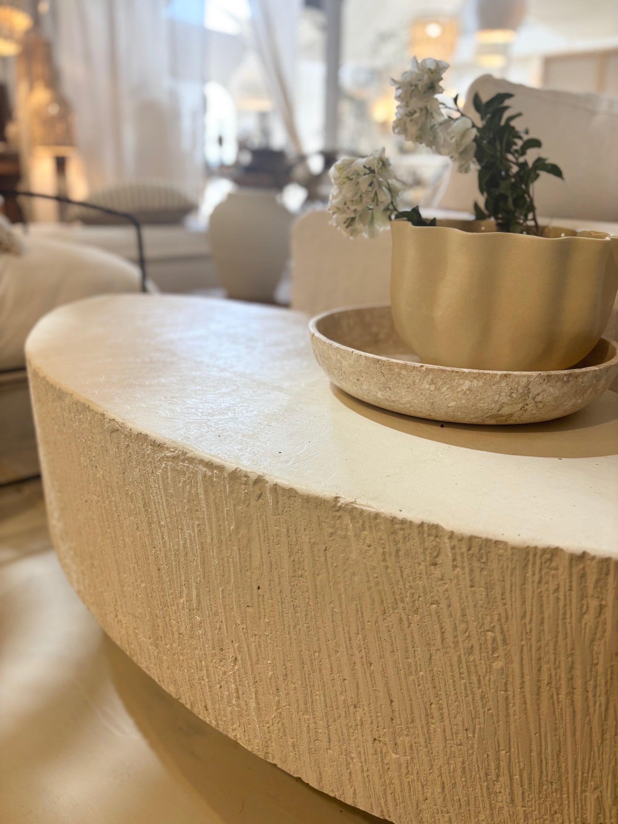 'Elena' GRC oval coffee table with rough stone appearance on the sides.