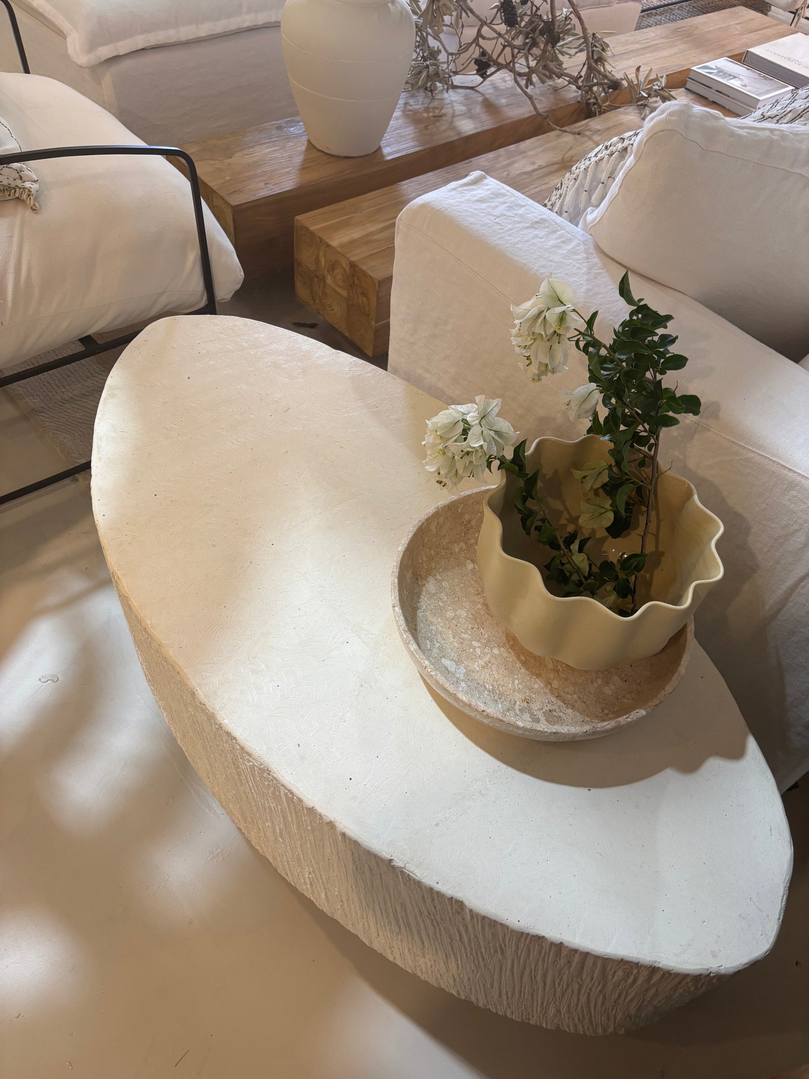 'Elena' GRC oval coffee table with rough stone appearance on the sides.