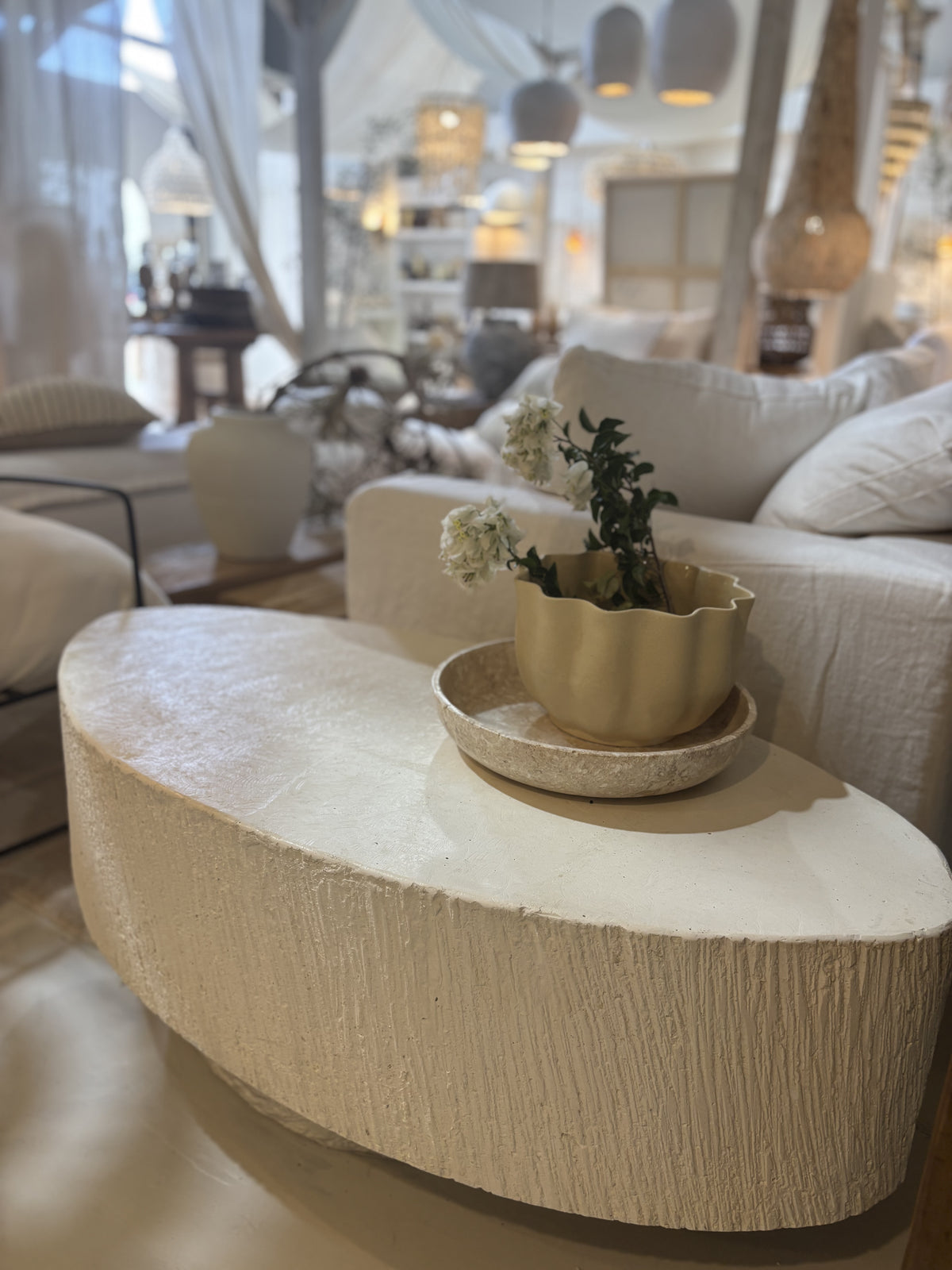 'Elena' GRC oval coffee table with rough stone appearance on the sides.