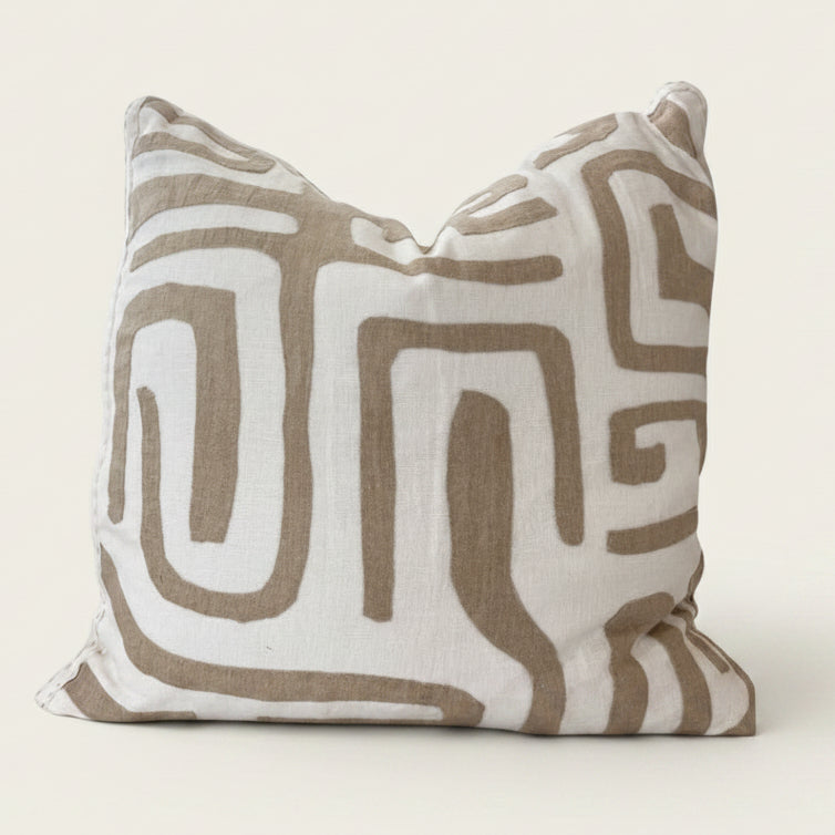 Decorative pillow with brown geometric pattern on a white background