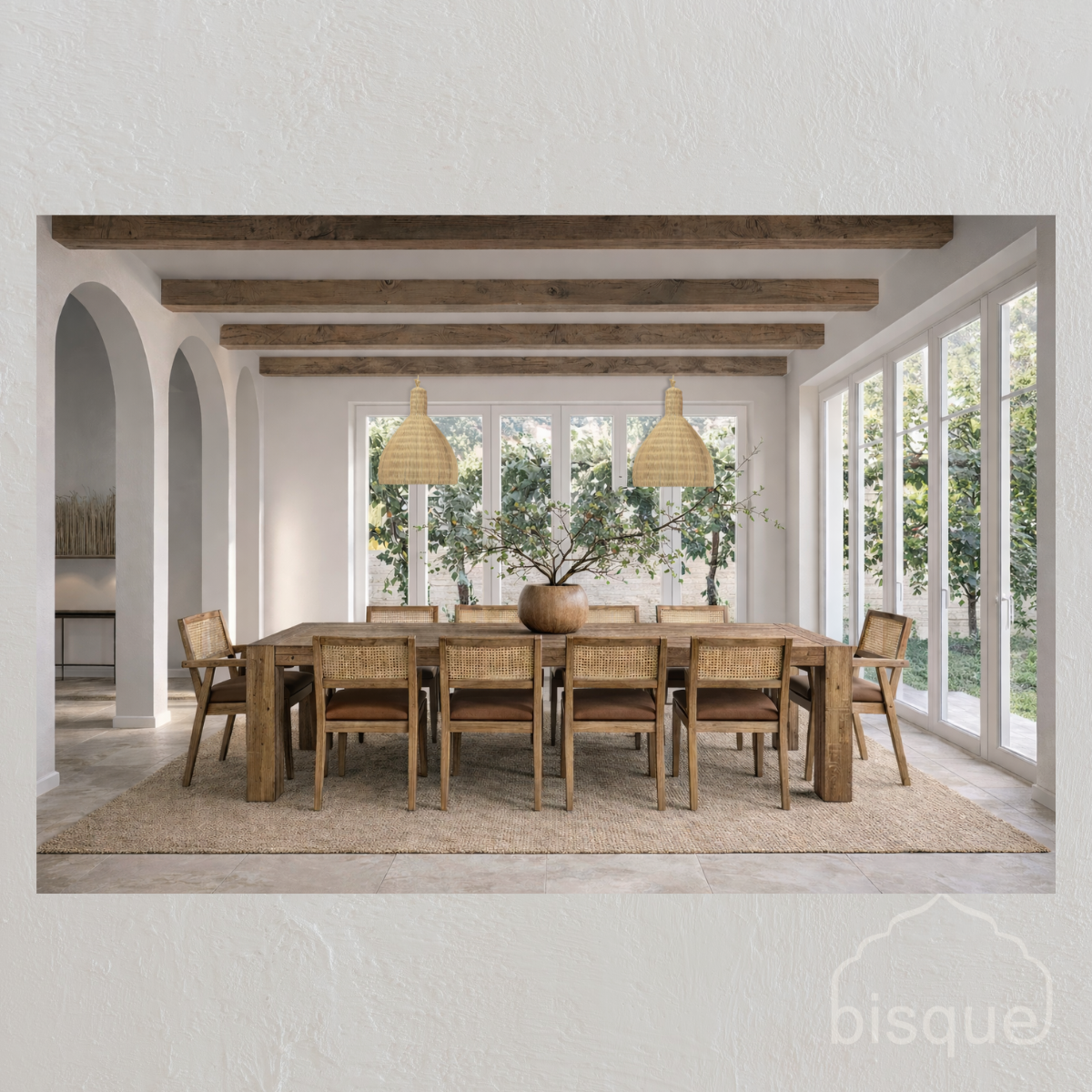 Dining room with reclaimed wood table and chairs, large windows, rattan pendant lights and 'bisque' branding.