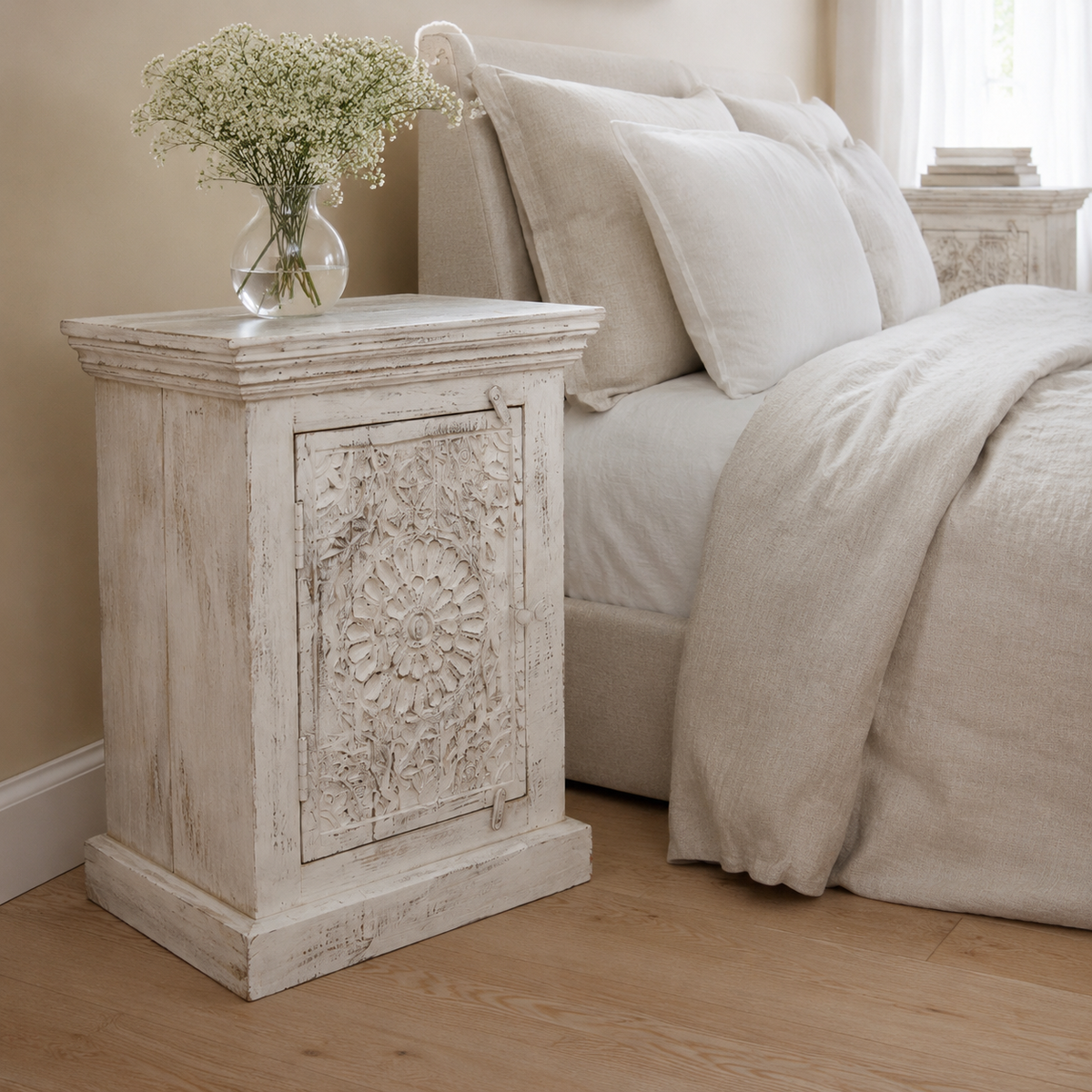 A distressed white carved wooden nightstand, indian antique with cornice and kickboard detailing. available in left and right side, with beautiful flower botanical relief.