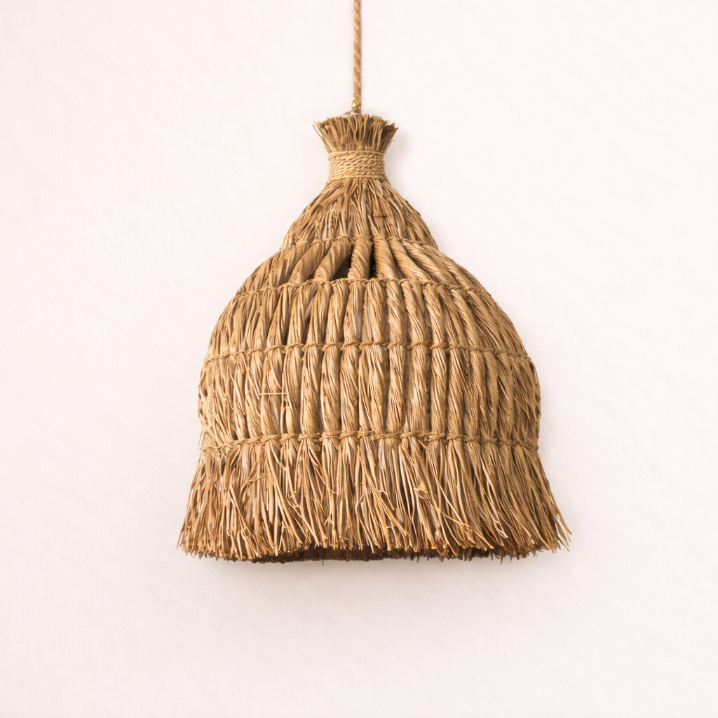 Woven Mande Pendant light hanging against a white background