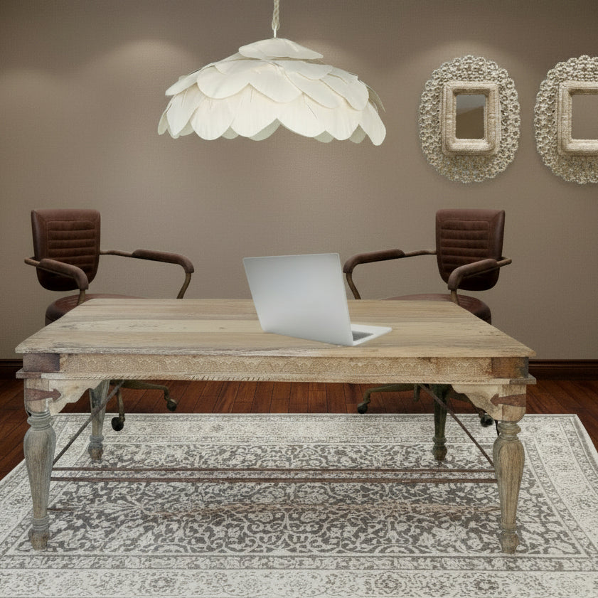 Collage of a wooden indian carved desk with chairs, a petal lamp, and indian peacock mirrors on wall.