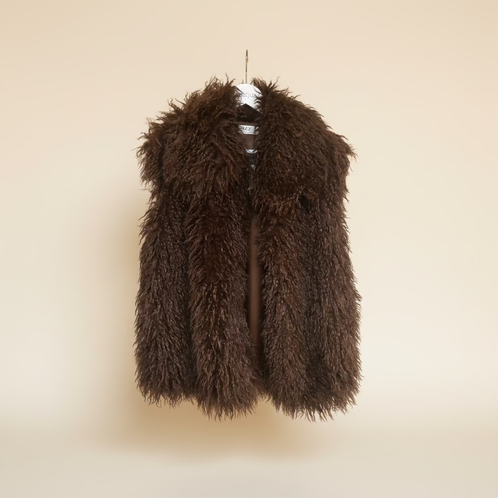 Brown mink faux fur vest hanging on a beige wall
