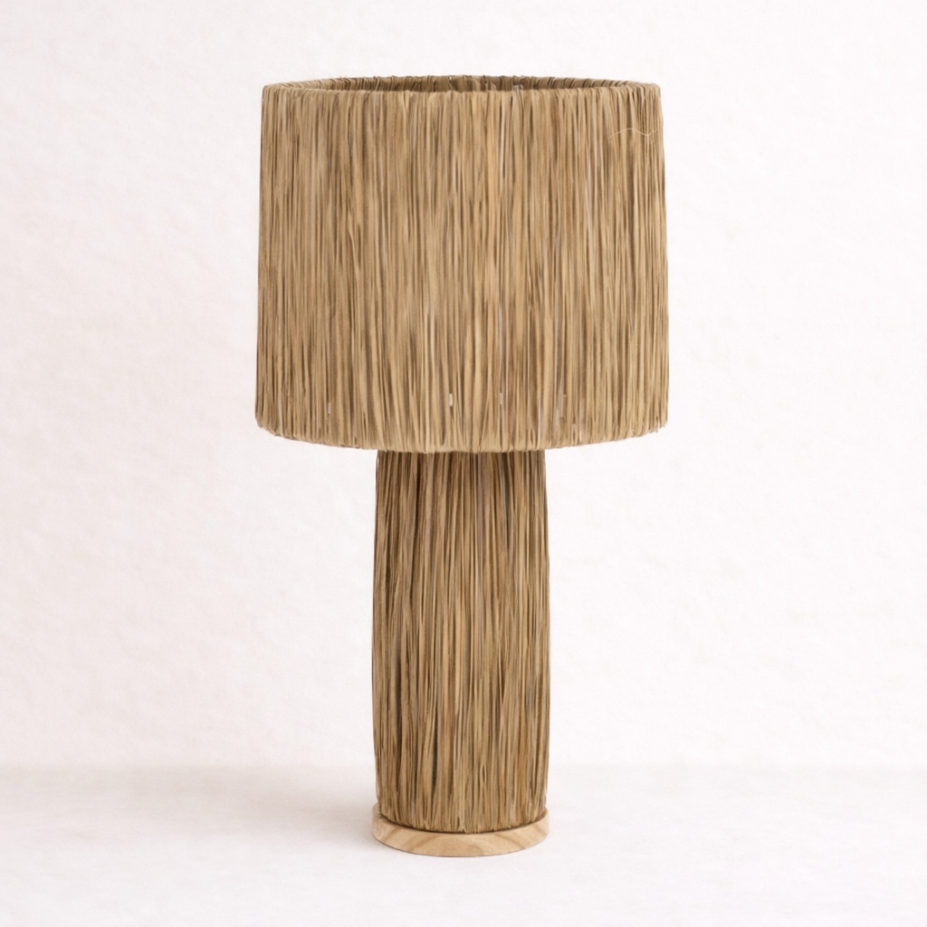 Raffia table lamp with a raffia shade on a white background